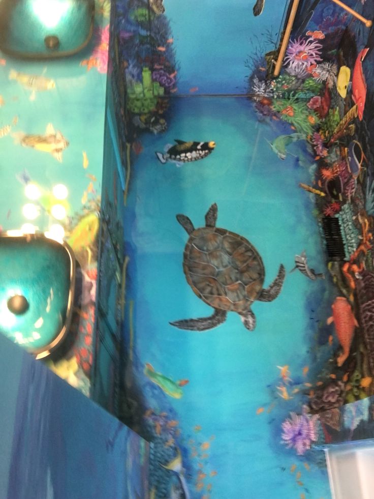 a painting of a turtle swimming in the ocean with other marine life on it's walls