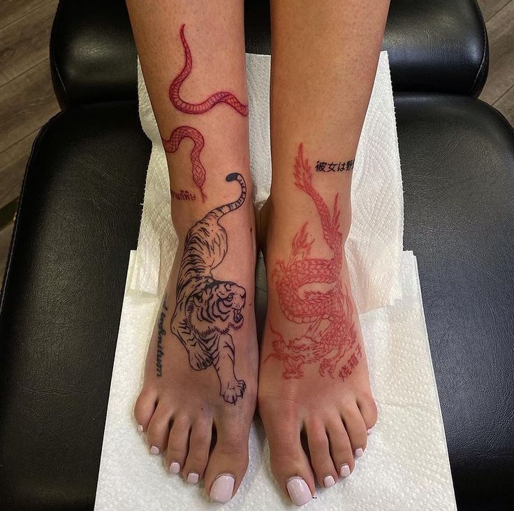 two people with tattoos on their feet sitting in a chair