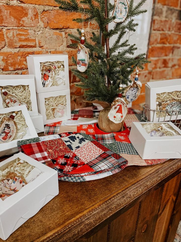 a christmas tree sits on top of a table with many cards and ornaments around it