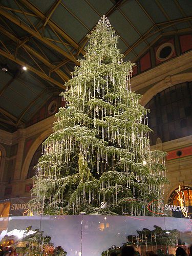 a large christmas tree is in the middle of a building