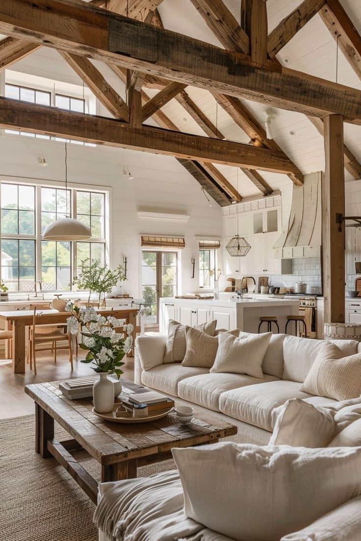 a living room filled with furniture and lots of windows