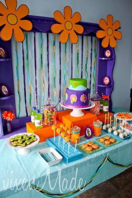 a table topped with lots of cakes and desserts