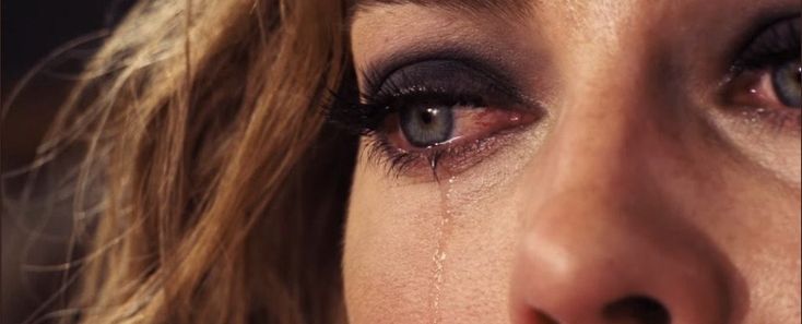 a woman's eye with teary tears on it