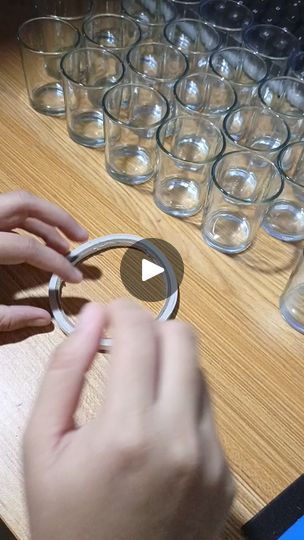 a person is working on some glass rings