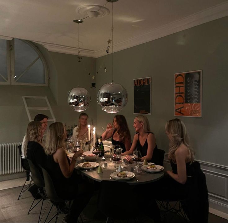 a group of women sitting around a dinner table