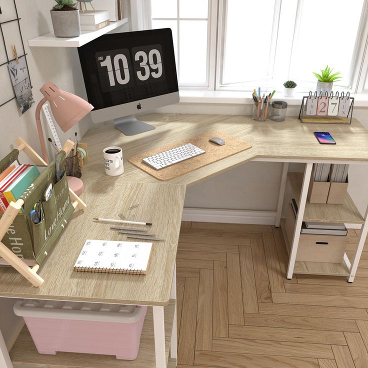 a desk with a computer monitor, keyboard and other office supplies on top of it