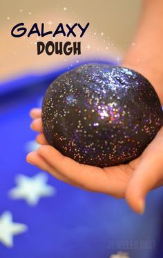 a person holding an object in their hand with the caption galaxy dough on it