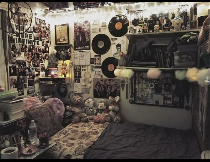 a room filled with lots of stuff animals and record records on the wall next to a bed