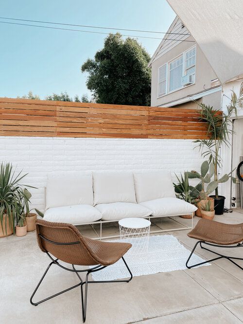 two chairs and a couch on a patio