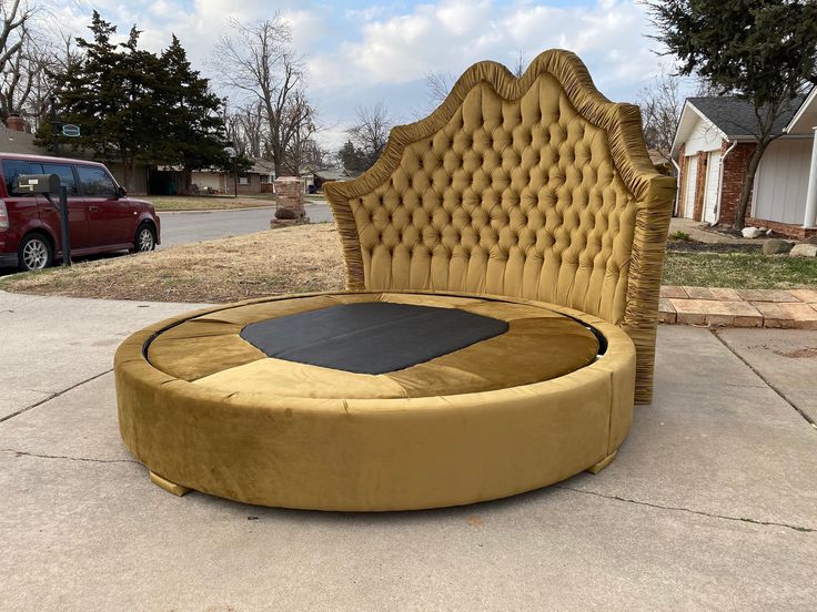 a large round bed sitting on top of a sidewalk