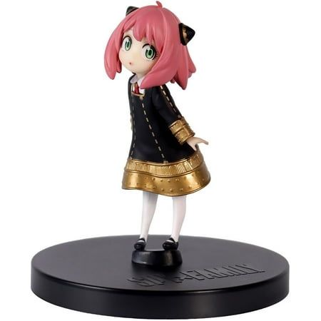 a figurine that is on top of a black and gold plated stand