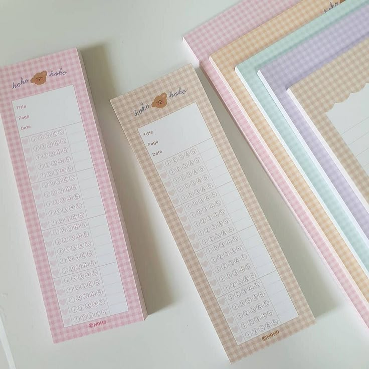 three pink and white checkered paper with numbers on them