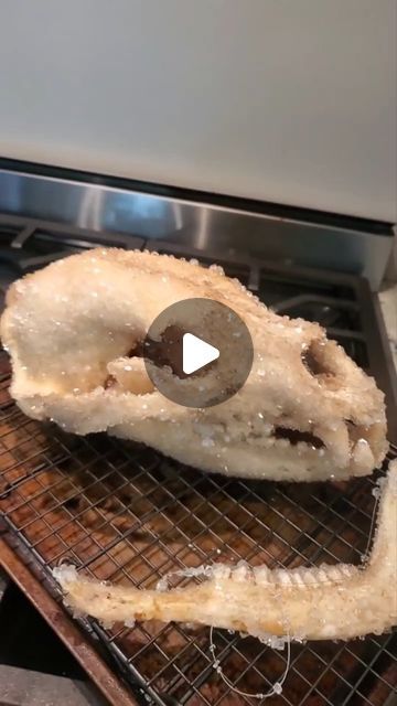 an uncooked doughnut on a cooling rack in front of a toaster oven