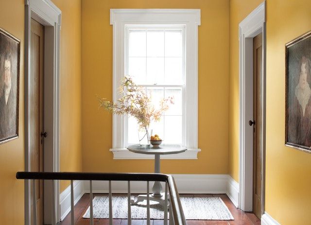 a room with yellow walls and white trim