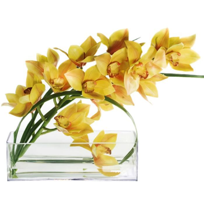 yellow flowers are in a clear glass vase