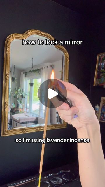 a person holding a match stick in front of a mirror that says how to lock a mirror so i'm using lavender incense