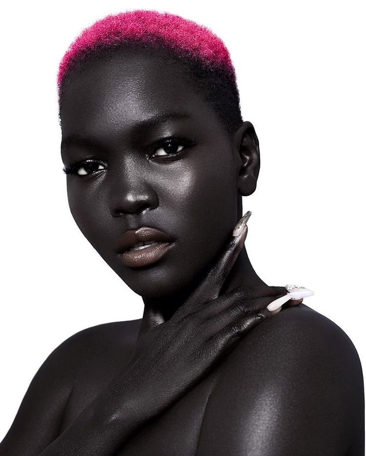 a woman with pink hair and black skin