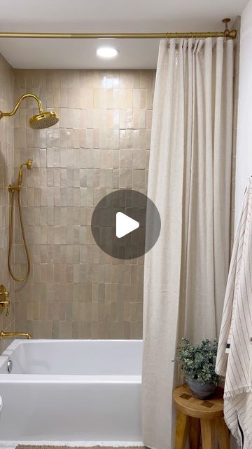 a bathroom with a tub, toilet and shower curtain