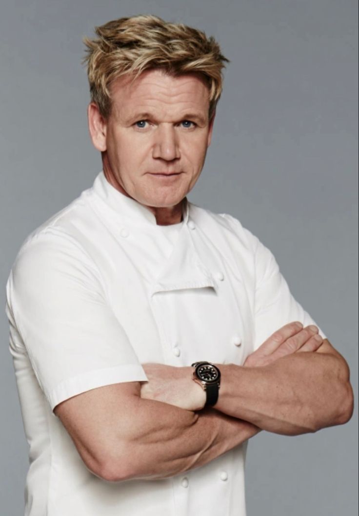 a man in a chef's uniform with his arms crossed