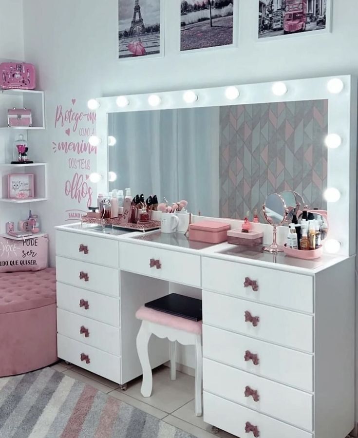 a white vanity with lights on it in a room next to a pink bench and rug