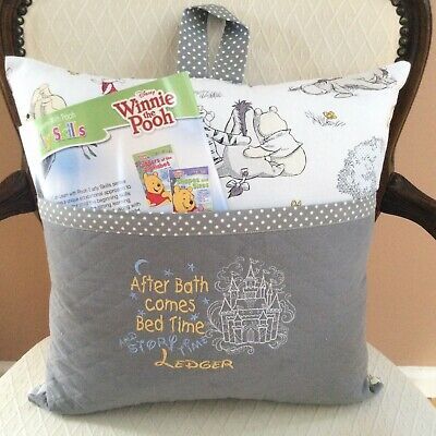 a pillow with winnie the pooh's bed time on it sitting on a chair