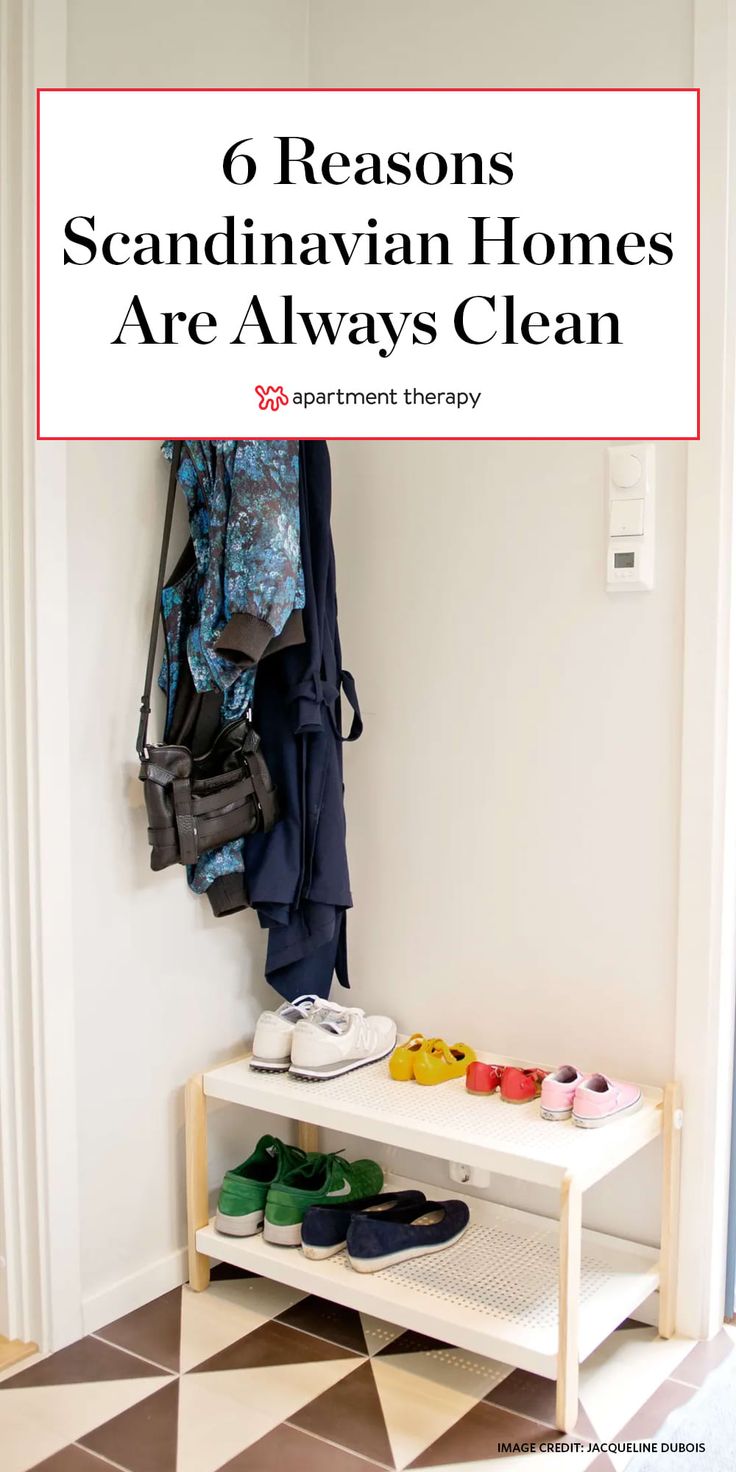 shoes are sitting on a shelf next to a coat rack