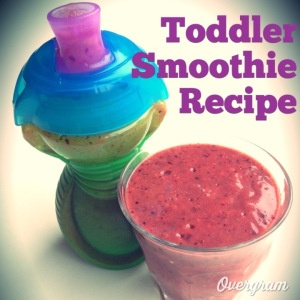 a smoothie in a glass next to a baby bottle with the words toddler smoothie recipe on it