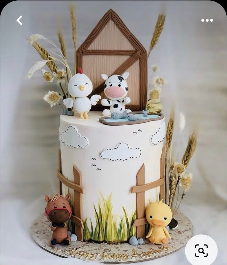 a cake decorated with farm animals on top of it