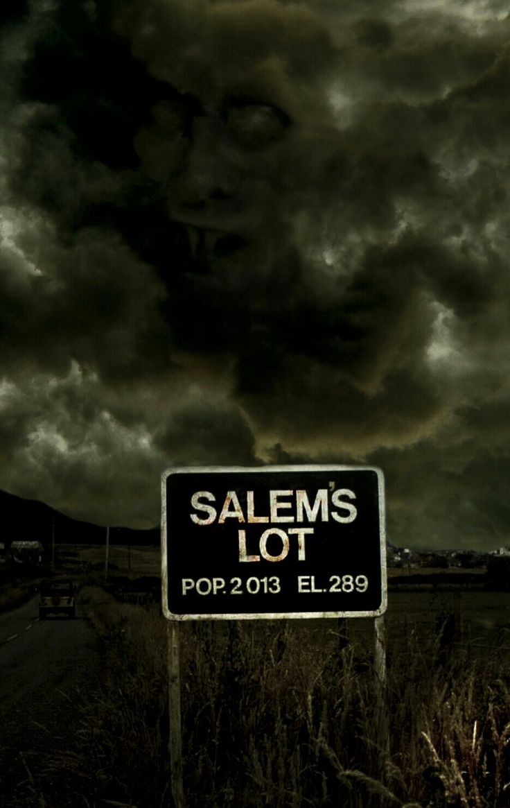 a sign that says salems lot on it in front of a dark sky with clouds