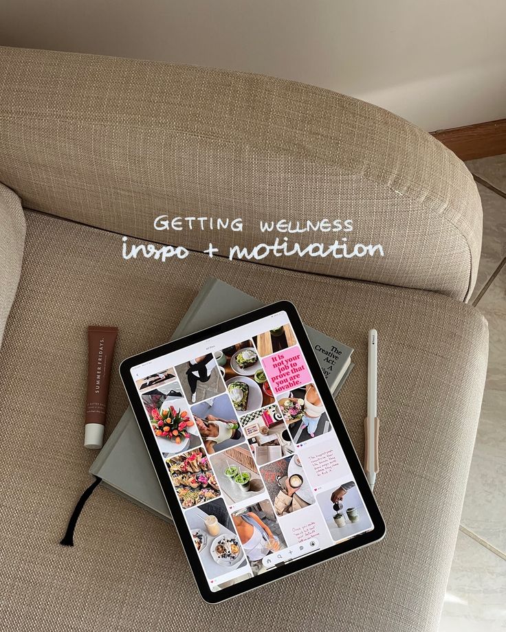 a tablet sitting on top of a couch next to a pen