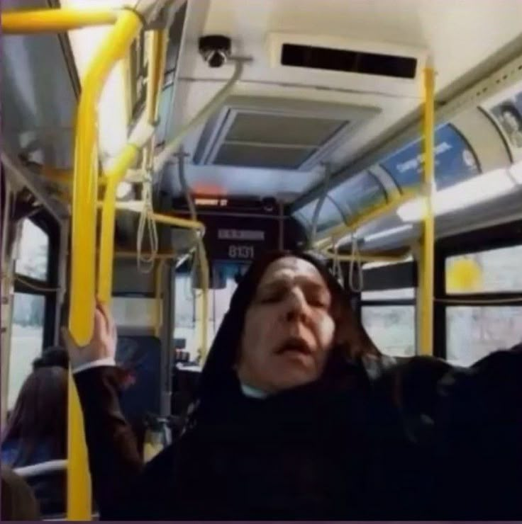 a woman on a bus with her eyes closed