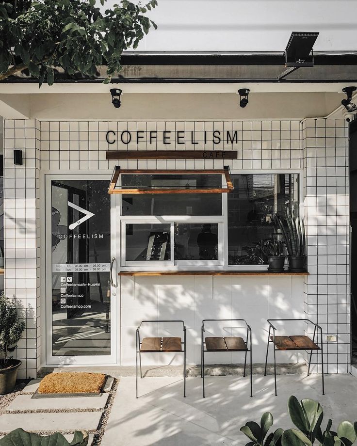 the front of a coffee shop with chairs outside