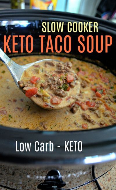 slow cooker keto taco soup in a crock pot with a spoon