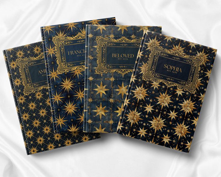 three black and gold books with golden stars on them