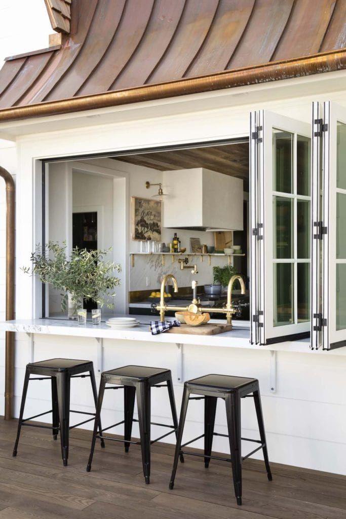 three stools sit in front of an open window on the outside of a house