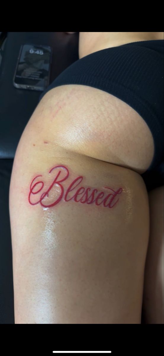 a woman with a tattoo on her thigh that says, be loved in cursive writing