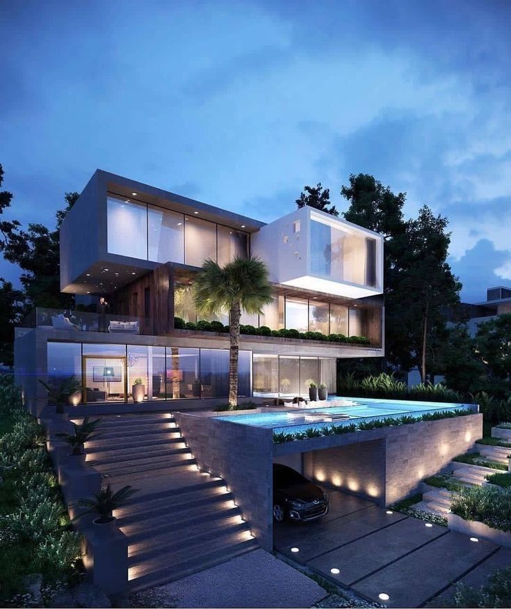 a large modern house with stairs leading up to the upper floor and above ground swimming pool