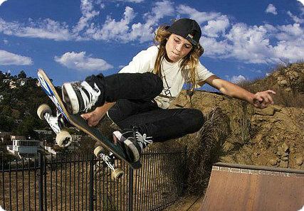 a skateboarder is doing a trick in the air over a fenced area