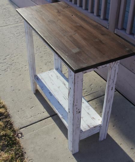 a wooden bench sitting on top of a sidewalk