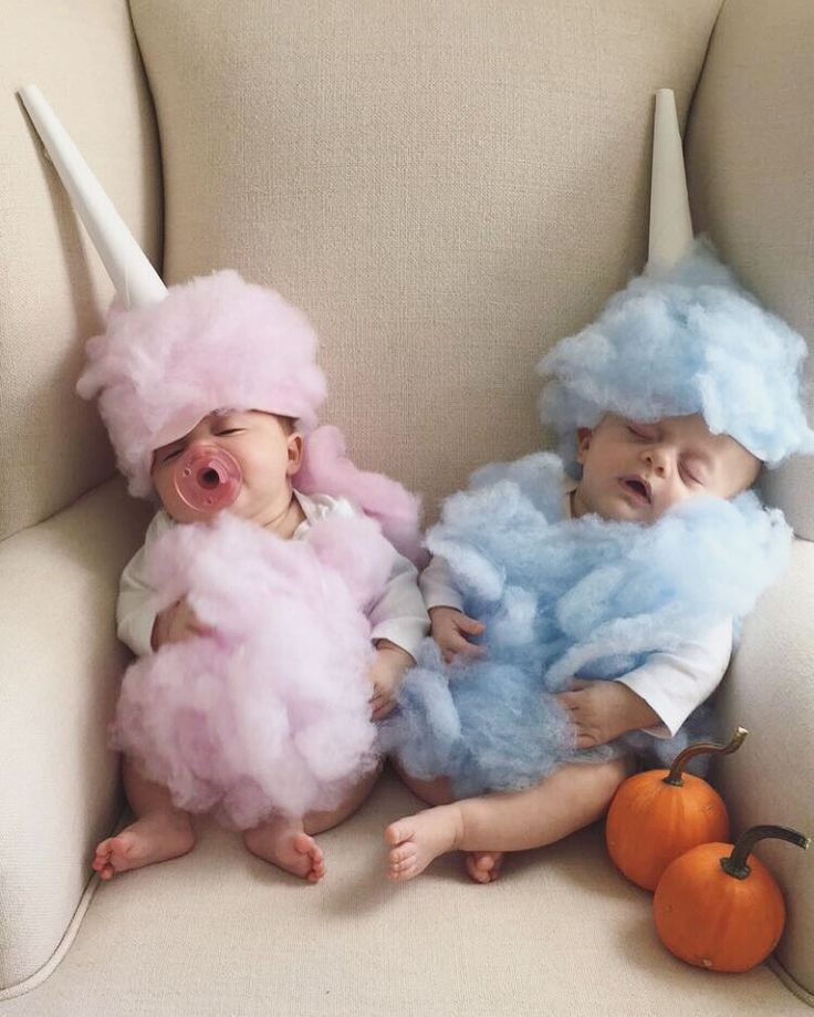 two babies dressed in costumes sitting next to each other