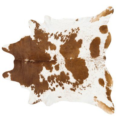 a brown and white cowhide rug on a white background