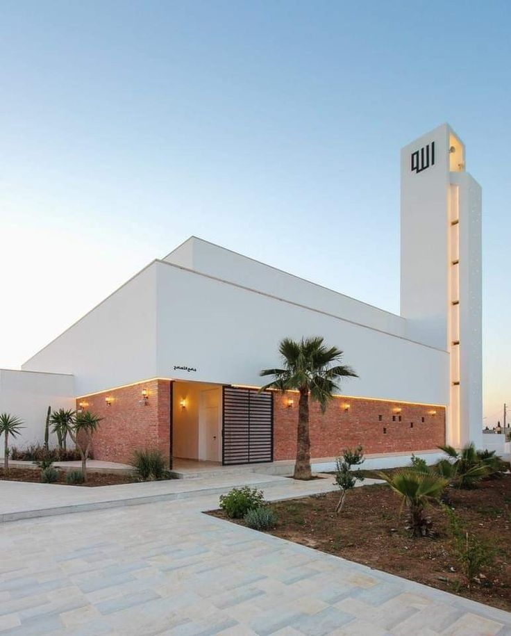 a white building with a clock tower in the background