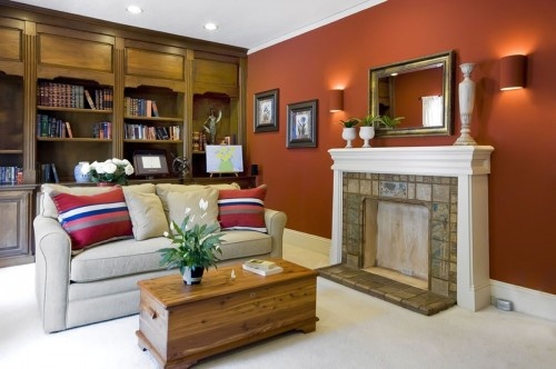 a living room filled with furniture and a fire place next to a book shelf full of books