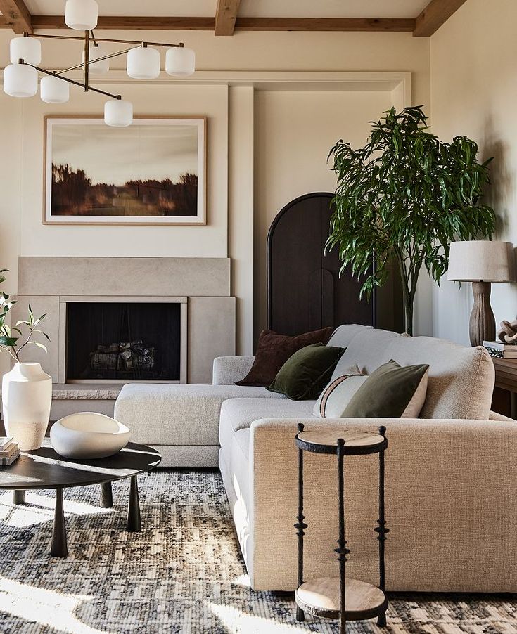 a living room filled with furniture and a fire place in front of a painting on the wall