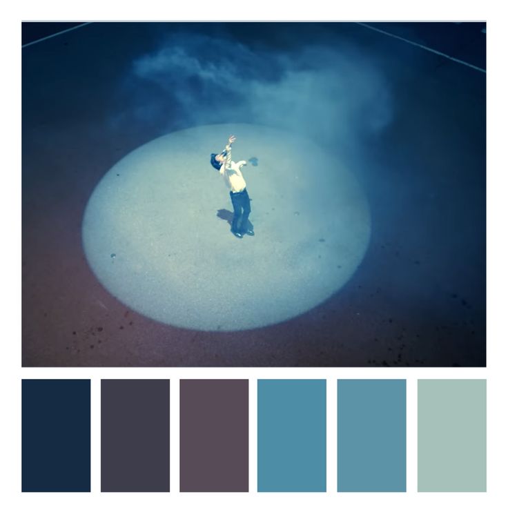 a person standing on top of a white circle in the middle of blue and gray colors