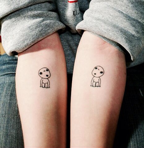 two people with small tattoos on their legs, one has a dog and the other has a cat