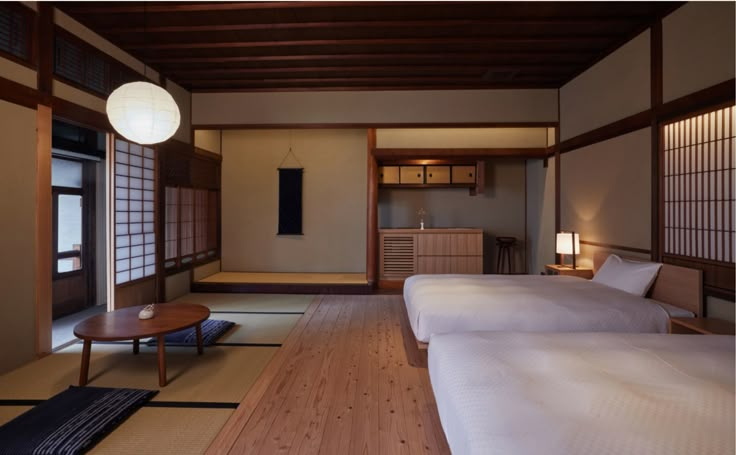 two beds sitting in a bedroom next to each other on top of a wooden floor