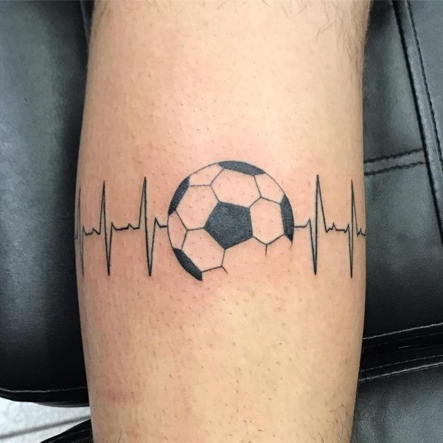 a soccer ball with heartbeat tattoo on the leg