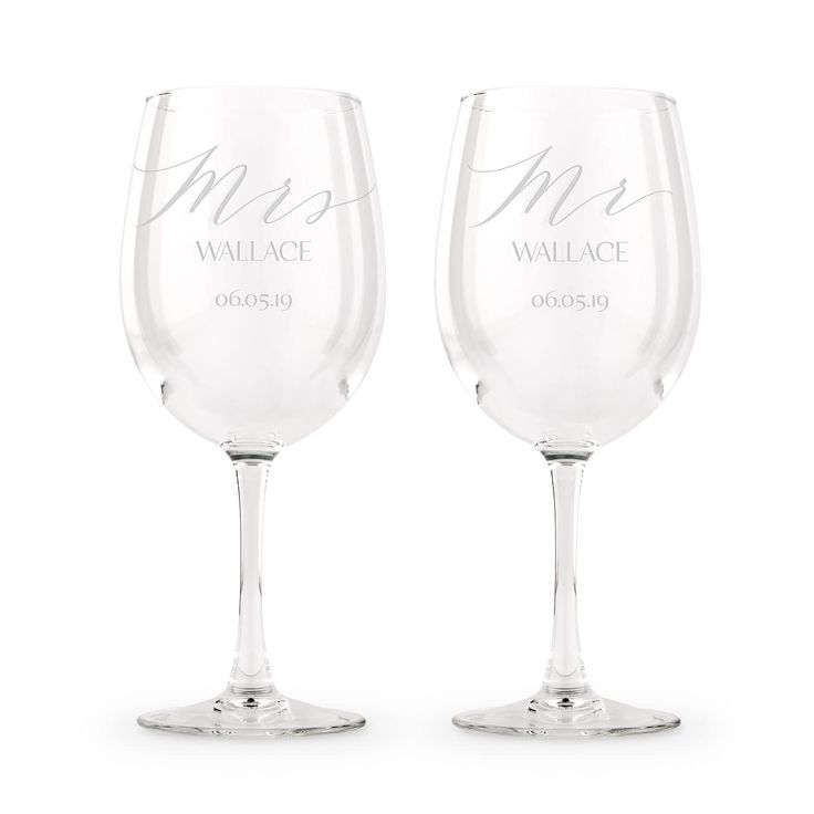 two personalized wine glasses sitting next to each other