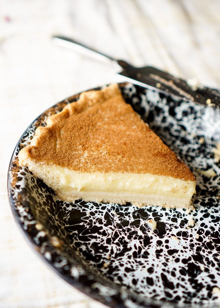 a piece of pie on a black and white plate